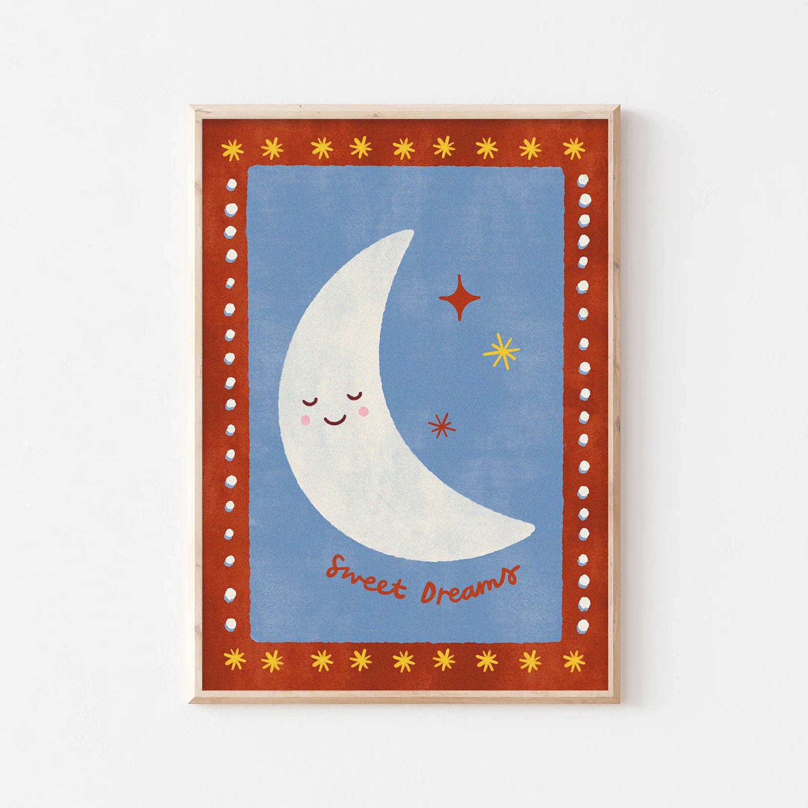 Framed artwork with a smiling moon and stars on a blue background
