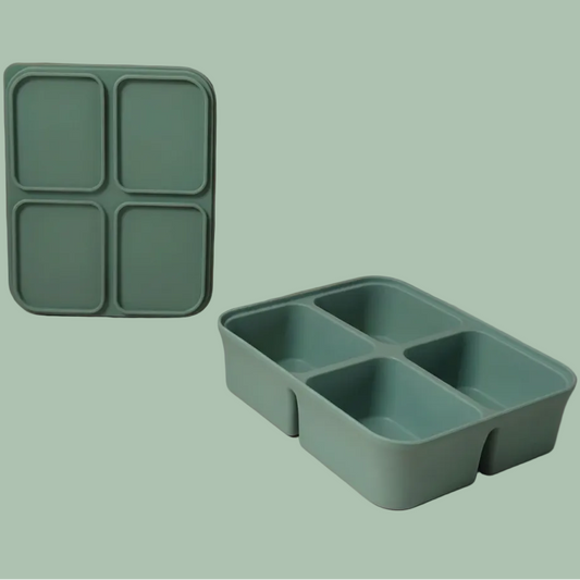 A mint green silicone bento box organizer shown in two views: one standing upright with four square compartments and one lying down in a four-compartment grid, set against a minimalist beige and dusty rose background.