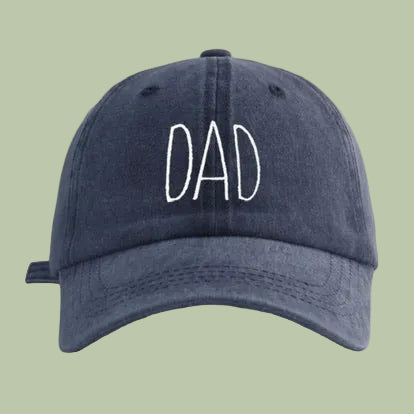 Navy blue cap with 'DAD' embroidered on a white background