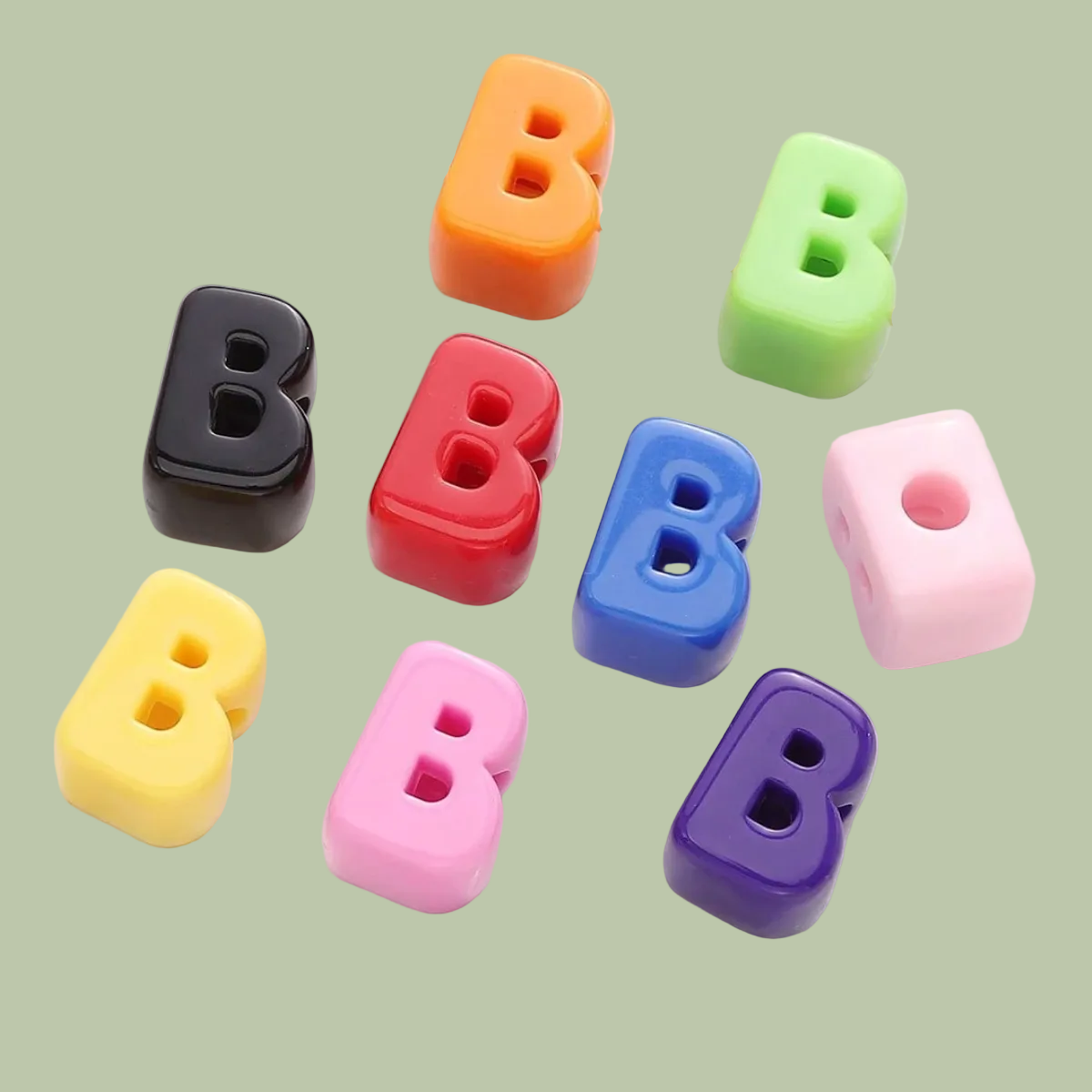 Colorful letter 'B' beads on a white plate