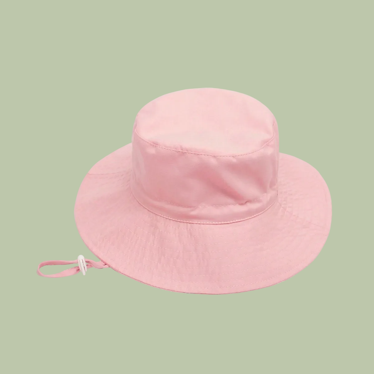 Pink bucket hat with a strap on a white background