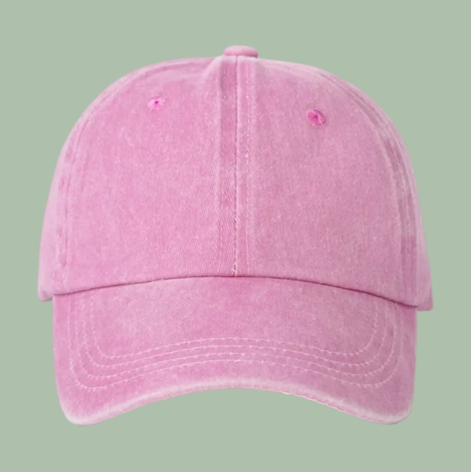 A pink washed cotton baseball cap shown from the front on a clean white background.