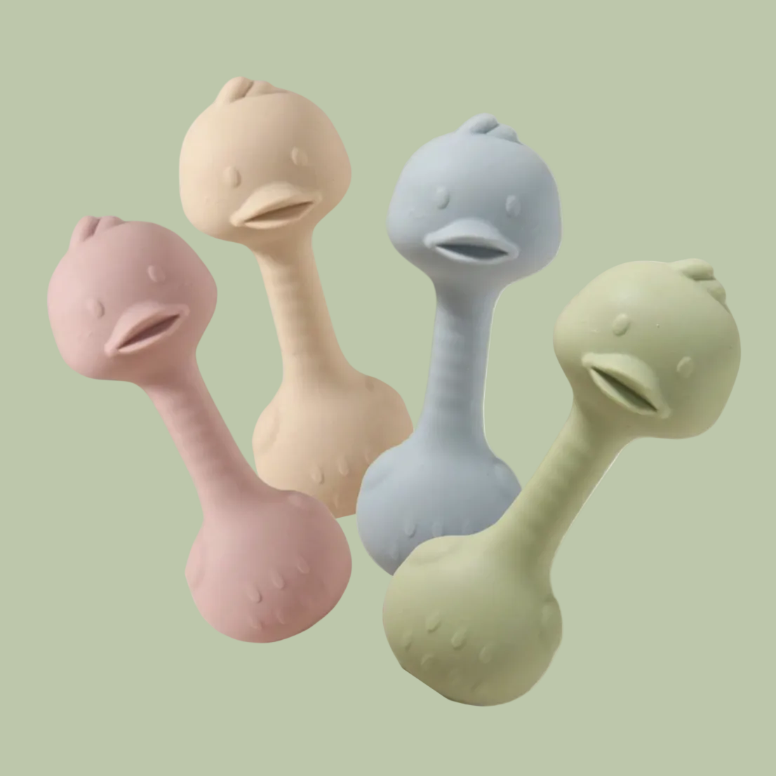 Four silicone duck-shaped rattles in different colors on a white background