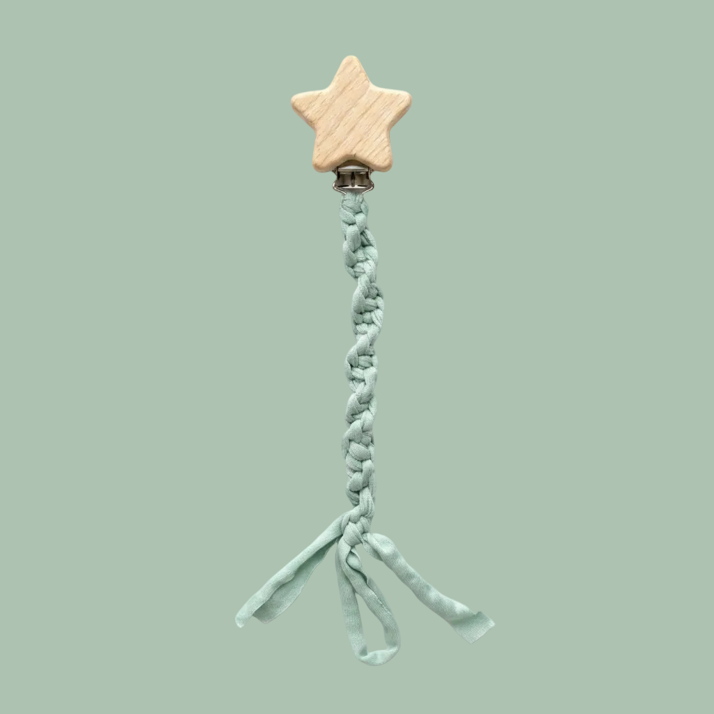 A baby teething ring featuring a natural wood star clip and a mint green braided fabric strap