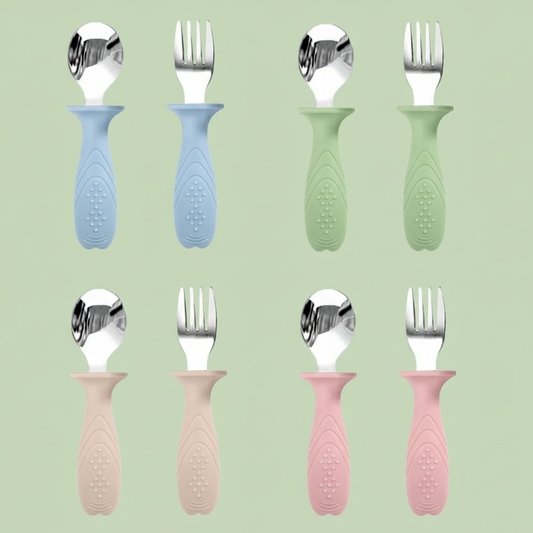 Pairs of children's cutlery with different colored handles on a white background