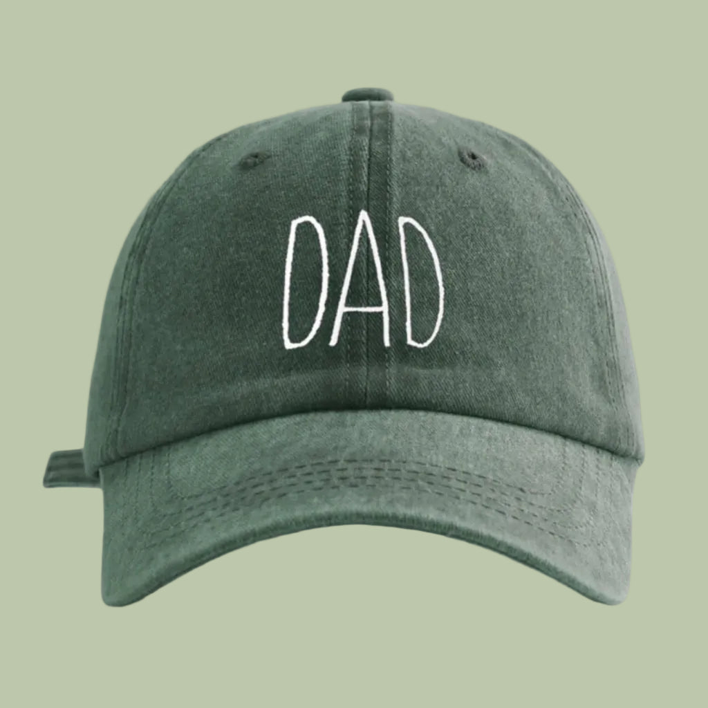 Green cap with 'DAD' embroidered on a white background