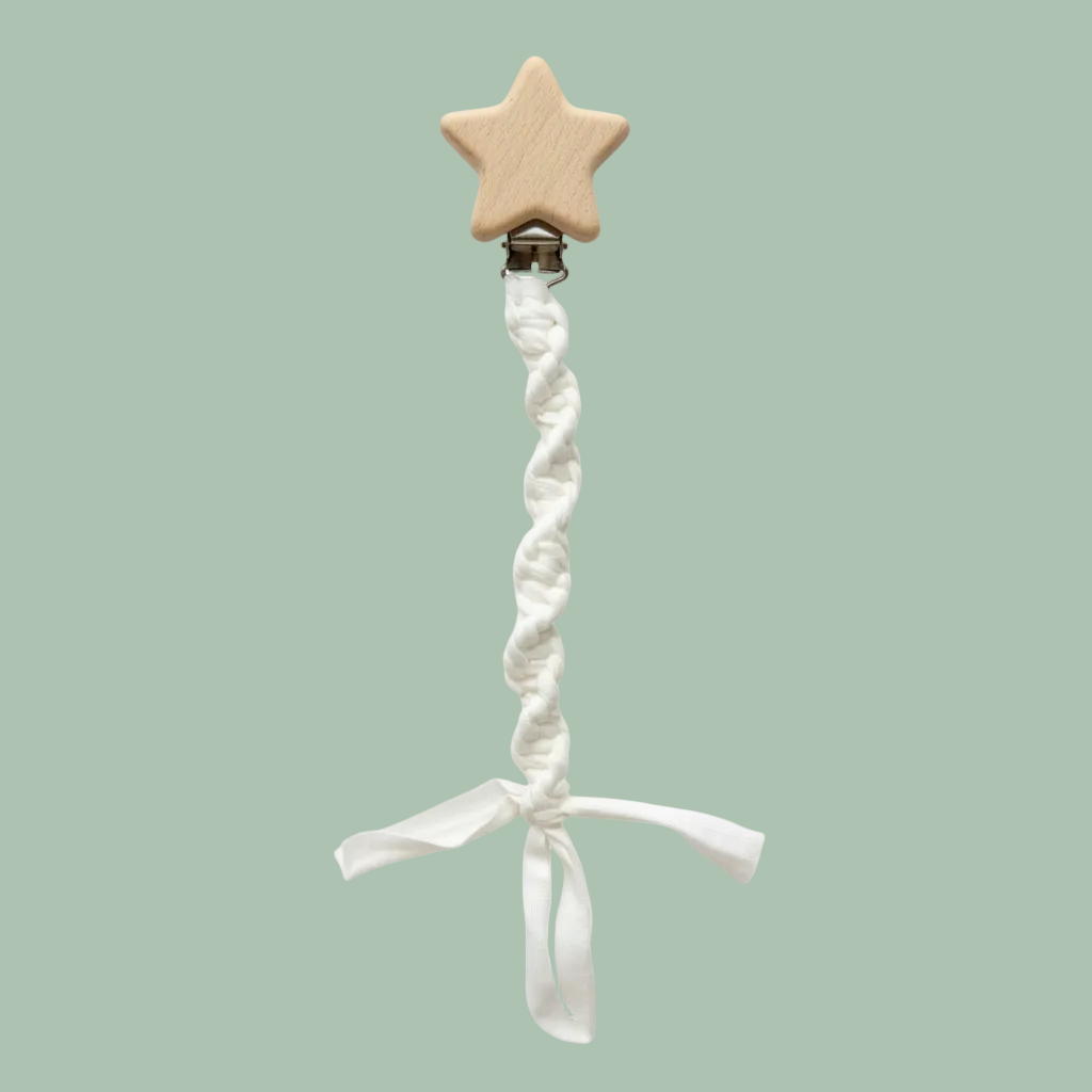 A wooden baby pacifier clip with a star-shaped wooden top and a braided white fabric strap